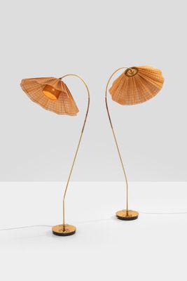 a pair of bamboo lamps on a white surface