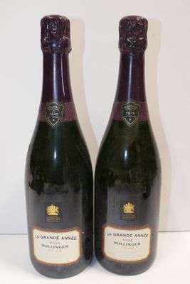 two bottles of wine are sitting on a table next to each other