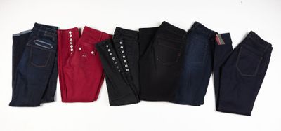 cinq paires de jeans alignées sur un fond blanc
