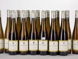 six bottles of wine lined up in a row on a table