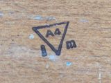 a close up of a piece of wood with a clock on it