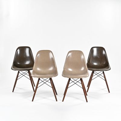 trois chaises Eames de couleurs et de tailles différentes sur un fond blanc