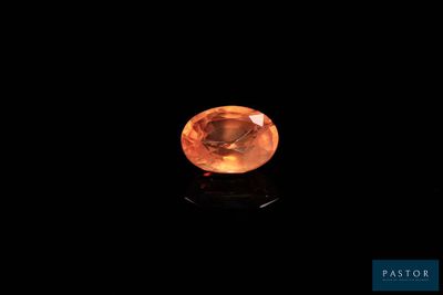 an orange sapphire stone on a black background