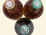 three bottles of beer sitting on top of each other