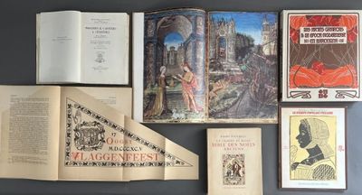 several old books are arranged on a table next to each other