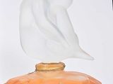 a glass figurine sitting on top of an orange box