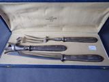 three silverware items in a blue case on a blue surface