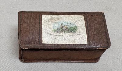 a small wooden box with a picture on it