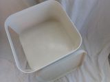 a white container sitting on top of a white sheet