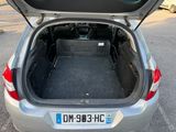 a trunk of a silver car with its trunk open