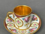 a close up of a cup and saucer on a table