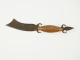 a wooden object with a metal handle on a white surface