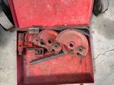 a red tool box with tools in it on the ground