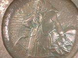 a silver plate with a picture of a woman and a dog