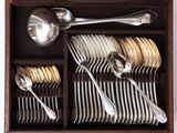 many spoons and silverware in a wooden box