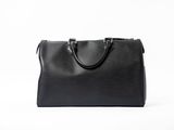 a black leather handbag on a white background