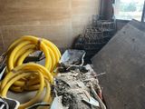 a pile of bananas sitting on the floor next to a pile of other items