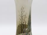 a glass vase with a picture of a church in the background