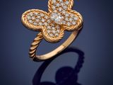 a gold and diamond flower ring, by van cleef