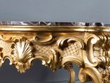 a gold table with a marble top on it