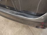a close up of the bumper of a car with a denting on it