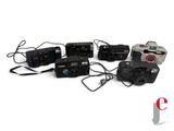 many cameras that are connected to each other on a white surface