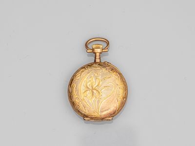 a gold pocket watch with a floral design on the dial