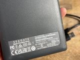 the back of a person holding a black cell phone in their hand