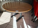 a round table with four chairs around it in a restaurant