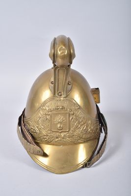 brass plated bell on a white surface with a white background