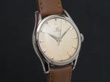 a close up of a watch with a brown leather strap