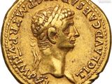 a gold coin with a woman ' s head and a crown on it