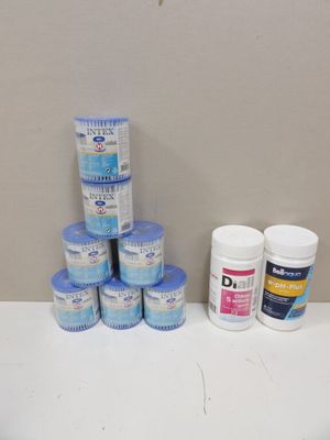 a pile of pills and a bottle of toothpaste on a counter
