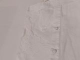 a close up of a pair of white pants on a bed