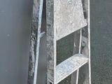 a ladder leaning against a wall next to a building