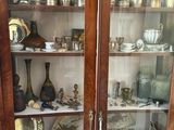 a display case with a lot of silver items in it