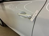 a close up of a car door handle with a sticker on it