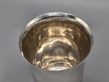 a silver cup that is sitting on a table