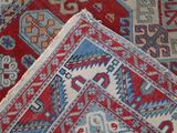 a close up of a red and blue oriental rug