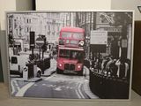 a picture of a red double decker bus going down the street
