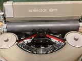 an old typewriter sitting on a table in a room