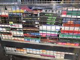a metal cart with many different types of cigarettes on it