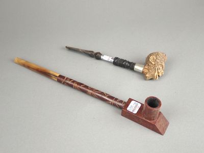 une pipe et un porte-pipe posés sur une table
