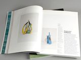a book opened to show a picture of a vase and a vase