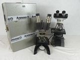three microscopes sitting next to each other on a table