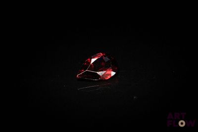 gros plan d'un diamant rouge sur une surface noire