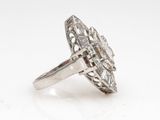 a close up of a diamond ring on a white surface