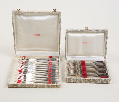 silverware in a silver case with red handles and a red handle
