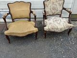 two chairs and a chair with a cushion are sitting in front of a garage