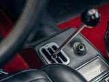 a close up of a car ' s interior with a red carpet